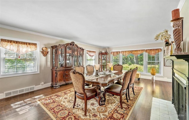 dining room with visible vents, ornamental molding, and plenty of natural light