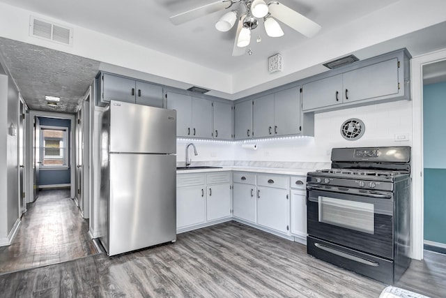 11549 S Kilbourn Ave, Alsip, IL 60803 - kitchen featuring freestanding refrigerator, visible vents, wood finished floors, gas stove, and a sink
