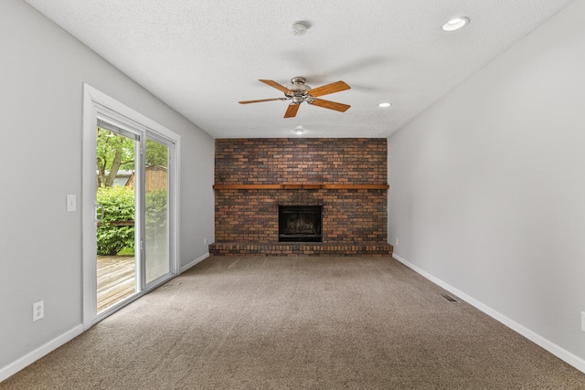 2409 Valkar Ln, Champaign, IL 61822 - unfurnished living room featuring carpet, a brick fireplace, ceiling fan, baseboards, and a textured ceiling