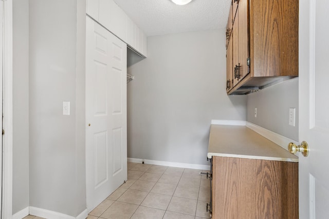 2409 Valkar Ln, Champaign, IL 61822 - laundry room featuring light tile patterned flooring, a textured ceiling, and baseboards