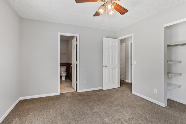 2409 Valkar Ln, Champaign, IL 61822 - unfurnished bedroom featuring carpet flooring, baseboards, a closet, ensuite bath, and a textured ceiling