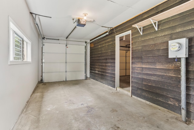 2409 Valkar Ln, Champaign, IL 61822 - garage with a garage door opener and wood walls