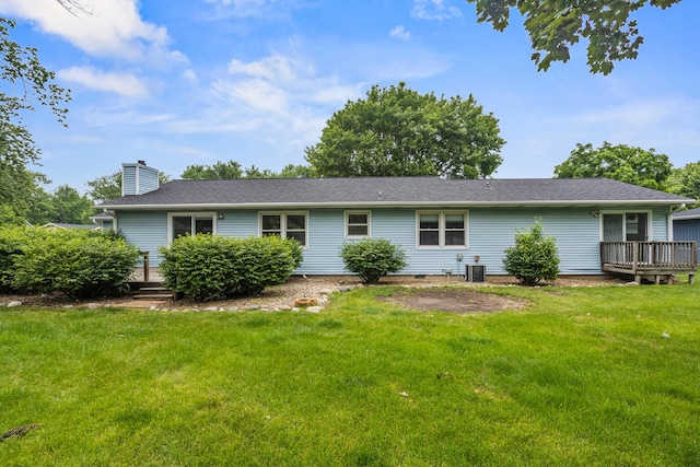 2409 Valkar Ln, Champaign, IL 61822 - rear view of property with a chimney, a yard, a wooden deck, and central AC unit