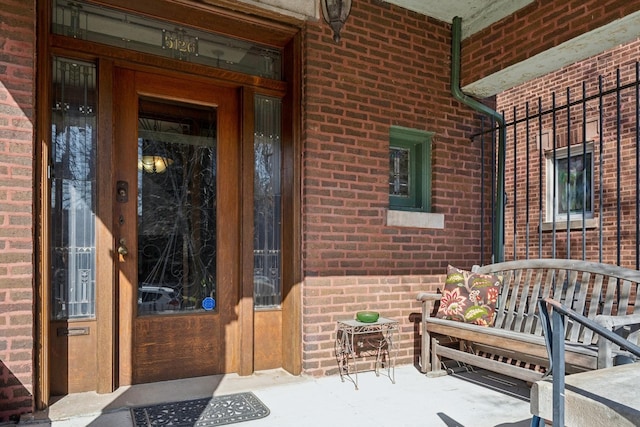 property entrance featuring brick siding