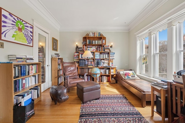 living area with crown molding and wood finished floors