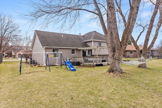 15306 S Heritage Dr, Plainfield, IL 60544 - rear view of house with a playground, cooling unit, a lawn, and roof with shingles