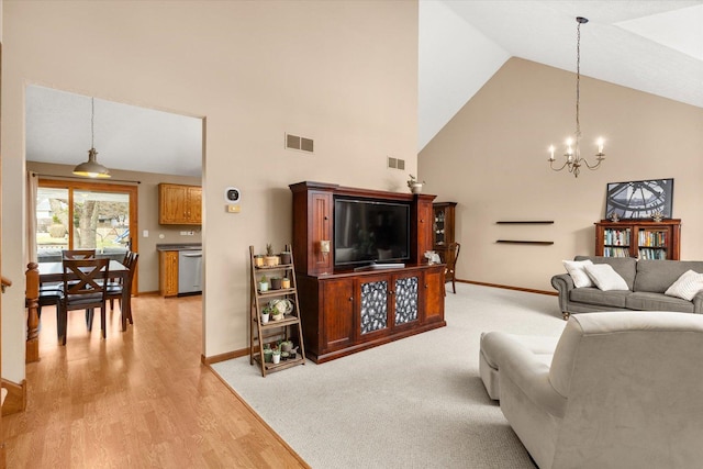 15306 S Heritage Dr, Plainfield, IL 60544 - living area featuring light wood-type flooring, high vaulted ceiling, a notable chandelier, and visible vents