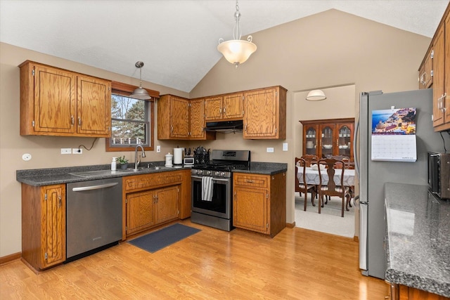 15306 S Heritage Dr, Plainfield, IL 60544 - kitchen featuring dark countertops, brown cabinetry, appliances with stainless steel finishes, and under cabinet range hood