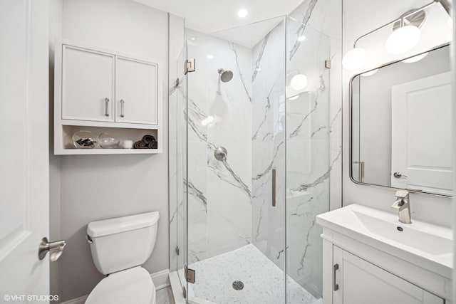 bathroom featuring a marble finish shower, toilet, recessed lighting, and vanity