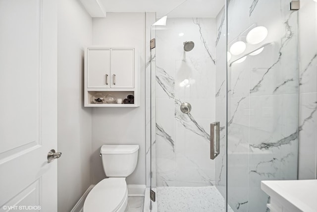 full bathroom with toilet, a marble finish shower, baseboards, and marble finish floor