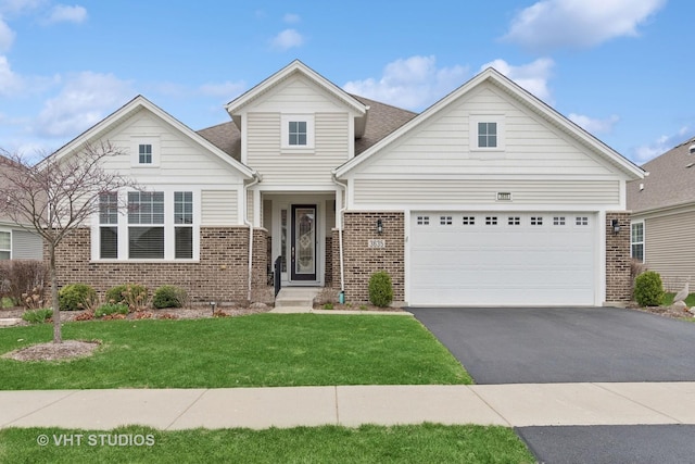 3635 Chesapeake Ln, Naperville, IL 60564 - view of front facade featuring an attached garage, aphalt driveway, a front lawn, and brick siding