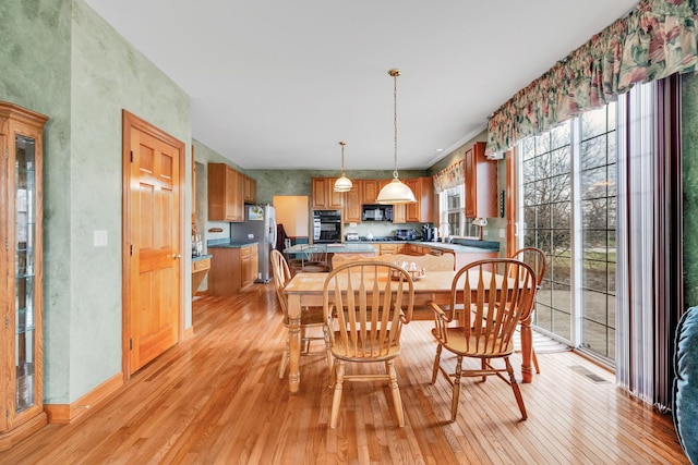 1581 Hunting Hound Ln, Bartlett, IL 60103 - dining space featuring light wood finished floors and visible vents