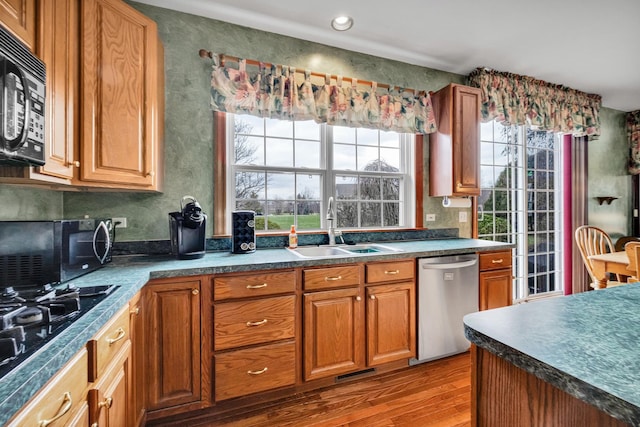 1581 Hunting Hound Ln, Bartlett, IL 60103 - kitchen featuring dark countertops, a sink, black appliances, and wood finished floors