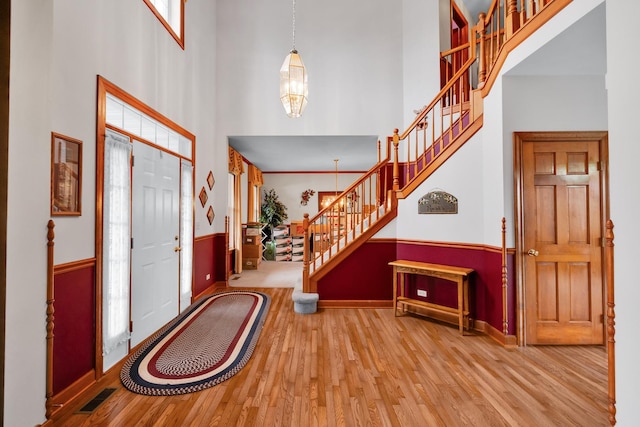 1581 Hunting Hound Ln, Bartlett, IL 60103 - entryway featuring visible vents, a high ceiling, wood finished floors, stairs, and baseboards