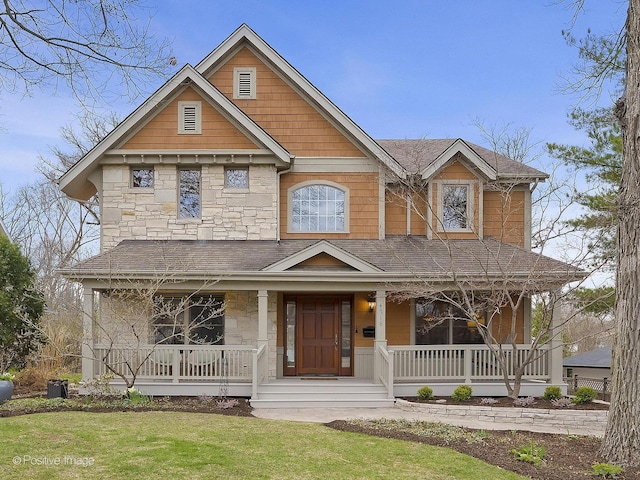 4716 Wallbank Ave, Downers Grove, IL 60515 - view of front of home featuring a porch, a shingled roof, stone siding, and a front lawn