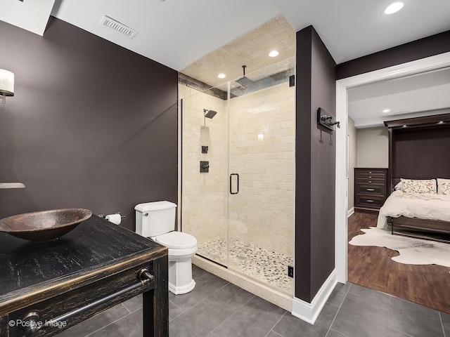 4716 Wallbank Ave, Downers Grove, IL 60515 - ensuite bathroom with toilet, tile patterned floors, a stall shower, and recessed lighting