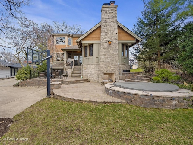 4716 Wallbank Ave, Downers Grove, IL 60515 - rear view of property featuring a yard, a patio, stone siding, and a chimney