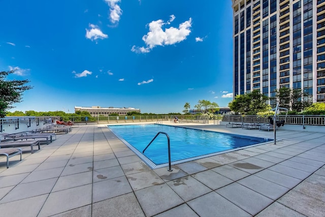 pool featuring a patio area and fence
