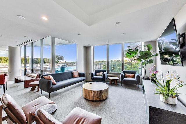 living area featuring recessed lighting and a wall of windows