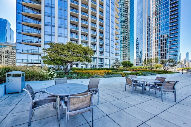 view of patio / terrace featuring outdoor dining space and a view of city