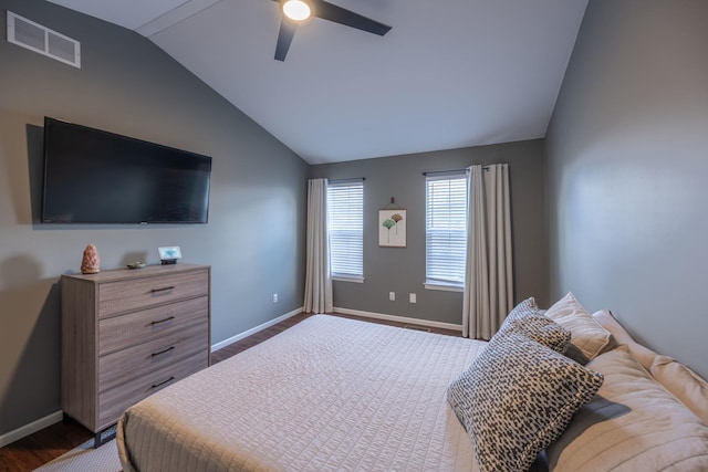 bedroom featuring dark wood-style flooring, visible vents, baseboards, and lofted ceiling