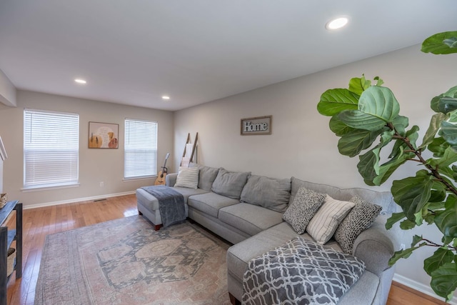 living area featuring wood finished floors, baseboards, and recessed lighting