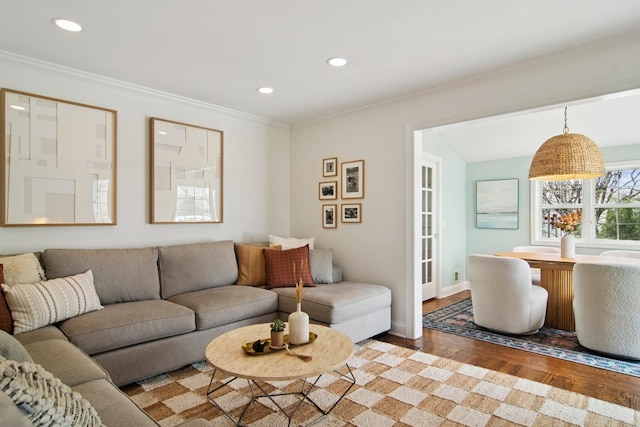 living room with ornamental molding, baseboards, recessed lighting, and wood finished floors