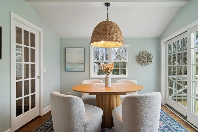 dining area with wood finished floors and vaulted ceiling