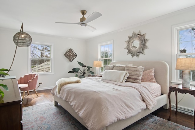 bedroom featuring crown molding, dark wood finished floors, and multiple windows
