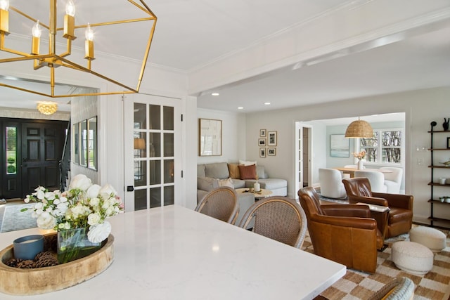 dining space featuring ornamental molding, recessed lighting, and an inviting chandelier