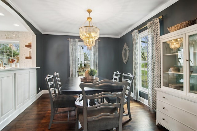 dining room with baseboards, an inviting chandelier, dark wood-style floors, crown molding, and arched walkways