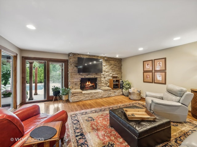living room with a healthy amount of sunlight, recessed lighting, wood finished floors, and a fireplace