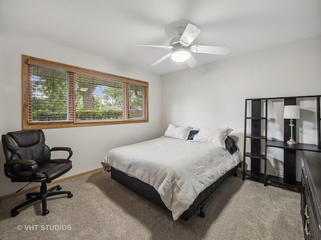 bedroom featuring baseboards, ceiling fan, and carpet