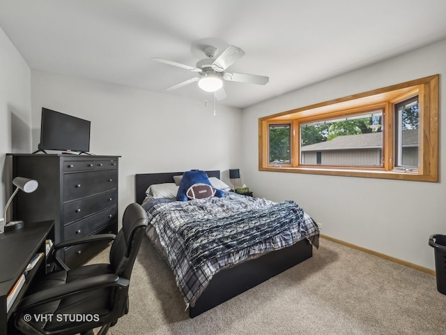 bedroom with ceiling fan, baseboards, and carpet