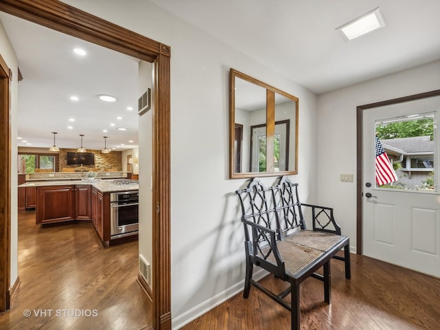 entryway featuring dark wood-type flooring, baseboards, visible vents, and recessed lighting