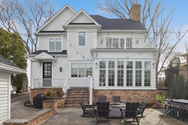 238 S Madison St, Hinsdale, IL 60521 - back of house with a patio area, a chimney, outdoor dining area, and a balcony