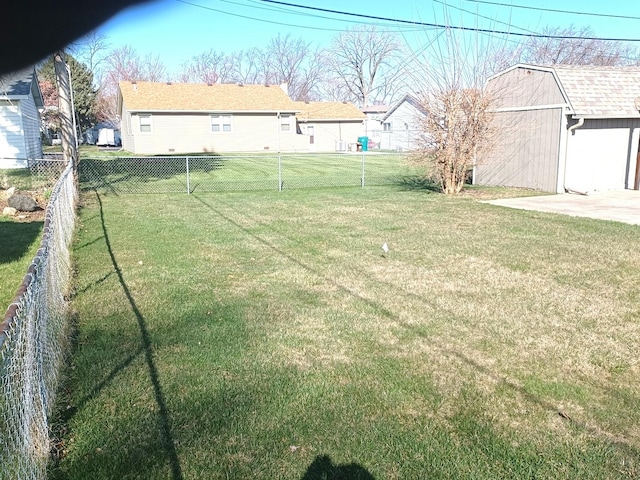 view of yard with an outbuilding and a fenced backyard