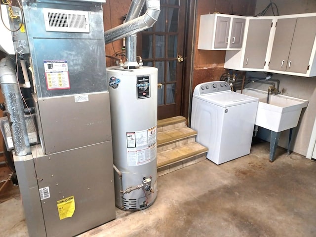 interior space with cabinet space, washer / clothes dryer, heating unit, and water heater