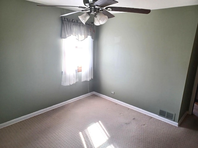 carpeted spare room featuring ceiling fan, baseboards, and visible vents