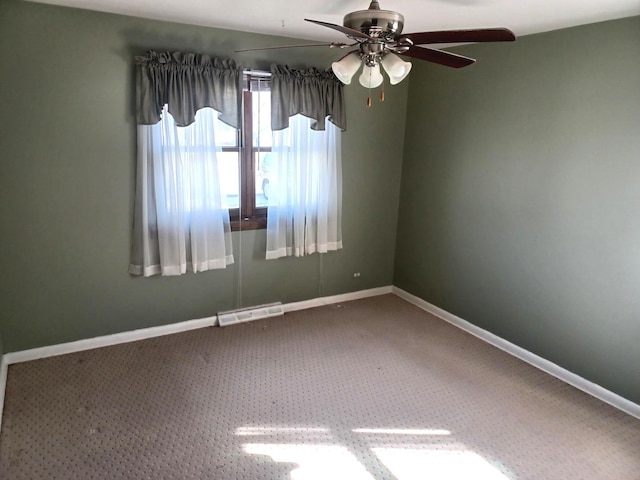 empty room with carpet, visible vents, baseboards, and a ceiling fan