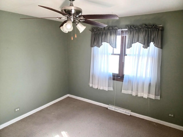 spare room with visible vents, baseboards, and ceiling fan
