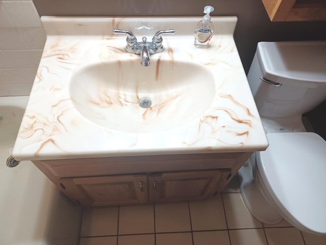 bathroom with tile patterned floors, vanity, and toilet