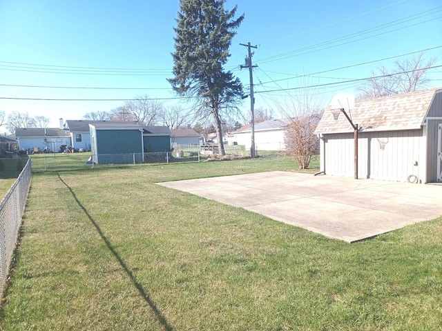 view of yard featuring an outbuilding, a fenced backyard, and a shed