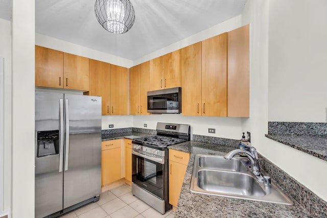 600 N Kingsbury St Unit 1114, Chicago, IL 60654 - kitchen featuring dark stone countertops, a chandelier, light tile patterned flooring, appliances with stainless steel finishes, and a sink