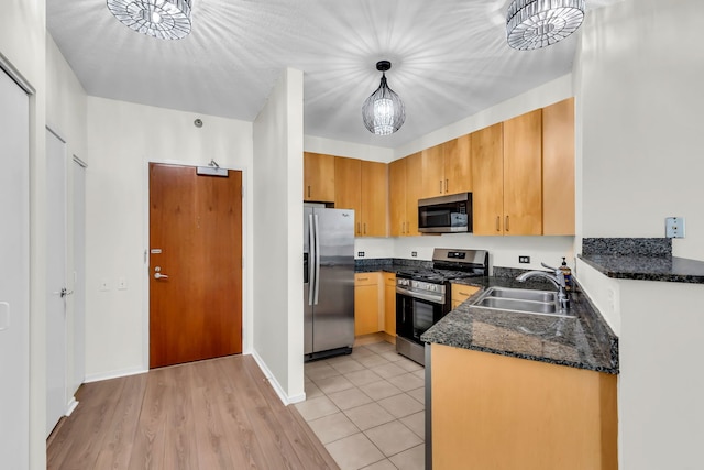 600 N Kingsbury St Unit 1114, Chicago, IL 60654 - kitchen with light tile patterned flooring, decorative light fixtures, dark stone counters, stainless steel appliances, and a sink