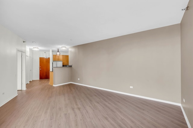 600 N Kingsbury St Unit 1114, Chicago, IL 60654 - unfurnished living room with light wood-style floors and baseboards