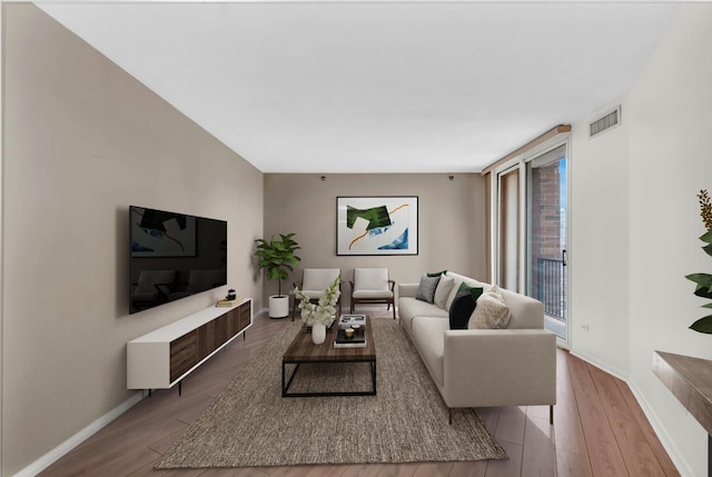 600 N Kingsbury St Unit 1114, Chicago, IL 60654 - living room featuring visible vents, baseboards, and wood finished floors