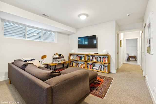 carpeted living room with visible vents and baseboards