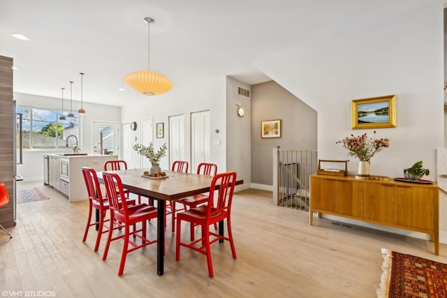 dining space with visible vents, baseboards, light wood-type flooring, and recessed lighting