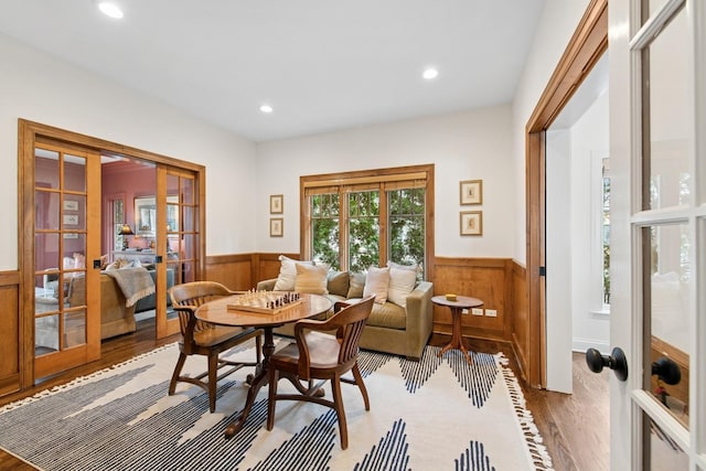 dining area with french doors, recessed lighting, wainscoting, and wood finished floors